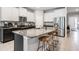 Kitchen features stainless steel appliances, a large island, granite countertops and seating at 13061 Brookside Moss Dr, Riverview, FL 33579