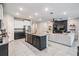 Modern kitchen with granite countertops, stainless steel appliances, and an island that opens to the living room at 13061 Brookside Moss Dr, Riverview, FL 33579