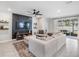 Bright living room featuring stylish accent wall, comfortable seating, and sliding glass doors at 13061 Brookside Moss Dr, Riverview, FL 33579