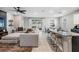 Open-concept living room with modern decor, spacious seating, and seamless access to the backyard at 13061 Brookside Moss Dr, Riverview, FL 33579