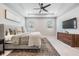 Main bedroom featuring a ceiling fan, tray ceiling and ample natural light at 13061 Brookside Moss Dr, Riverview, FL 33579