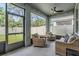 Screened-in patio with wicker furniture, a ceiling fan, and views of the fenced backyard at 13061 Brookside Moss Dr, Riverview, FL 33579