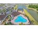 Aerial view of the community pool, clubhouse, tennis courts, playground, and parking lot at 13061 Brookside Moss Dr, Riverview, FL 33579