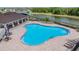 Aerial view of a spacious community pool with lounge chairs and tables at 13061 Brookside Moss Dr, Riverview, FL 33579