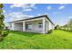 Backyard with covered patio and well-maintained lawn at 13631 Sunlight Meadow Dr, Riverview, FL 33578