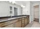 Bathroom vanity with dual sinks, wood cabinetry and large mirror at 13631 Sunlight Meadow Dr, Riverview, FL 33578