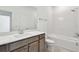 Bright bathroom showcasing white countertop, tiled tub, and modern fixtures at 13631 Sunlight Meadow Dr, Riverview, FL 33578