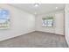 Cozy bedroom with plush carpeting, two windows and neutral paint colors at 13631 Sunlight Meadow Dr, Riverview, FL 33578