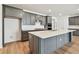 Modern kitchen featuring stainless steel appliances, granite countertops, and a spacious center island at 13631 Sunlight Meadow Dr, Riverview, FL 33578