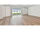 Bright living room with wood floors, recessed lighting, and sliding glass doors leading to the backyard at 13631 Sunlight Meadow Dr, Riverview, FL 33578