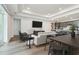 Bright and airy living room boasts recessed lighting, an entertainment center, and an open concept to kitchen at 13631 Sunlight Meadow Dr, Riverview, FL 33578