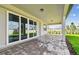 This home features a covered patio with brick pavers and sliding glass doors to the interior of the home at 13631 Sunlight Meadow Dr, Riverview, FL 33578