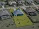 An aerial view of the home with well-manicured lawn and landscaping and neighborhood at 13805 Carryback Dr, Dade City, FL 33525