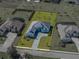 An aerial view of the home showcasing its landscaped yard and architectural design in a suburban setting at 13805 Carryback Dr, Dade City, FL 33525