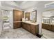 Bathroom with double vanity, large mirror, great storage, and marble floors at 13805 Carryback Dr, Dade City, FL 33525