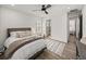 Bedroom featuring a comfy bed, wood floors, an area rug, and access to the bathroom at 13805 Carryback Dr, Dade City, FL 33525