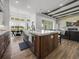 Modern kitchen with island, farmhouse sink, breakfast nook, and living space with fireplace at 13805 Carryback Dr, Dade City, FL 33525