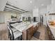 Open-concept kitchen features an island with seating, seamlessly connected to the living space at 13805 Carryback Dr, Dade City, FL 33525