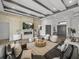 Bright living room boasts a stone fireplace, beamed ceilings, and stylish modern furnishings at 13805 Carryback Dr, Dade City, FL 33525