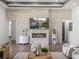 Living room with stone fireplace and ample natural light is perfect for entertaining guests or relaxing at 13805 Carryback Dr, Dade City, FL 33525