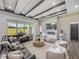 Comfortable living room with a cozy fireplace, stylish decor, and a view of the landscaped backyard at 13805 Carryback Dr, Dade City, FL 33525