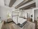 Bright main bedroom with decorative beam ceiling, canopy bed, and wood-style flooring at 13805 Carryback Dr, Dade City, FL 33525