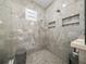 Close up of primary bathroom featuring tiled walk-in shower with rain shower head at 13805 Carryback Dr, Dade City, FL 33525