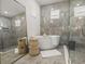 Bright primary bathroom featuring tiled walk-in shower with rain shower head at 13805 Carryback Dr, Dade City, FL 33525