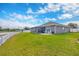 Charming home features a spacious backyard, screened lanai, and tranquil water views at 14417 Barley Field Dr, Wimauma, FL 33598