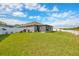 Spacious backyard featuring green grass and a screened patio area, perfect for outdoor living at 14417 Barley Field Dr, Wimauma, FL 33598