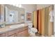 Bathroom featuring neutral walls, a wood vanity and cabinets, and a shower/bath combo at 14417 Barley Field Dr, Wimauma, FL 33598