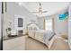 Cozy bedroom features a ceiling fan and TV, creating a welcoming and comfortable space at 14417 Barley Field Dr, Wimauma, FL 33598