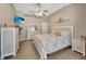 Neutral bedroom featuring a television, ceiling fan and decorative wall art at 14417 Barley Field Dr, Wimauma, FL 33598