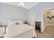 Bedroom featuring vaulted ceilings, white bedding, and light blue paint at 14417 Barley Field Dr, Wimauma, FL 33598