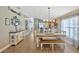 Open concept dining room featuring a wooden table with bench seating and stylish decor at 14417 Barley Field Dr, Wimauma, FL 33598