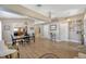 Open concept dining area with modern light fixture, view to kitchen, and light wood flooring at 14417 Barley Field Dr, Wimauma, FL 33598