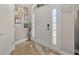 Inviting entryway with a white door, sidelights, transom window, and decorative wall shelves at 14417 Barley Field Dr, Wimauma, FL 33598