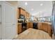 Spacious kitchen with wood cabinets, granite countertops, and modern black appliances at 14417 Barley Field Dr, Wimauma, FL 33598
