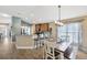 Open concept kitchen with bar seating and view to the dining room at 14417 Barley Field Dr, Wimauma, FL 33598