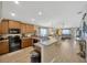 Open kitchen design with a breakfast bar, stainless steel appliances, and a view of the living area at 14417 Barley Field Dr, Wimauma, FL 33598