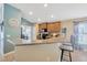 Charming kitchen with granite counters, breakfast bar, wood cabinets, and stainless steel appliances at 14417 Barley Field Dr, Wimauma, FL 33598