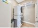 Convenient laundry room featuring a stacked washer and dryer set, maximizing space and efficiency at 14417 Barley Field Dr, Wimauma, FL 33598