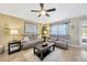 Cozy living room featuring plush seating, a ceiling fan, and bright, inviting decor at 14417 Barley Field Dr, Wimauma, FL 33598