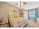 Serene main bedroom with a cozy king bed, bedside tables, and soft natural light from the window at 14417 Barley Field Dr, Wimauma, FL 33598