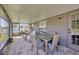 Covered back patio featuring brick flooring, a dining table set, and cushioned furniture at 14417 Barley Field Dr, Wimauma, FL 33598