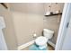 Small toilet room featuring a white toilet, small shelf, and a plush blue carpet at 14417 Barley Field Dr, Wimauma, FL 33598