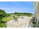 Expansive backyard with a patio, swing, grill, and scenic views of a pond at 18161 Hunters Meadow Walk, Land O Lakes, FL 34638