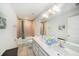 Well-lit bathroom features a double vanity, tiled floors, and shower-tub combination at 18161 Hunters Meadow Walk, Land O Lakes, FL 34638