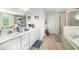 Bathroom featuring double sinks, a walk-in shower, and a soaking tub at 18161 Hunters Meadow Walk, Land O Lakes, FL 34638