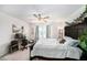 Bright bedroom features a ceiling fan, a work station, and natural light from a window at 18161 Hunters Meadow Walk, Land O Lakes, FL 34638